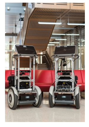 (a) Two SegBots from the Building-Wide Intelligence Project at UT Austin.