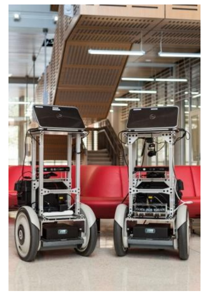 Fig. 2: Platforms in use by the UT Austin Villa RoboCup@Home Team. (a) Two BWIBots from the Building-Wide Intelligence Project. (b) SegBot with mounted Kinova Mico arm. (c) Custom robot used in Niekum's laboratory. (d) Dreamer is a compliant humanoid robot used in Sentis's laboratory.