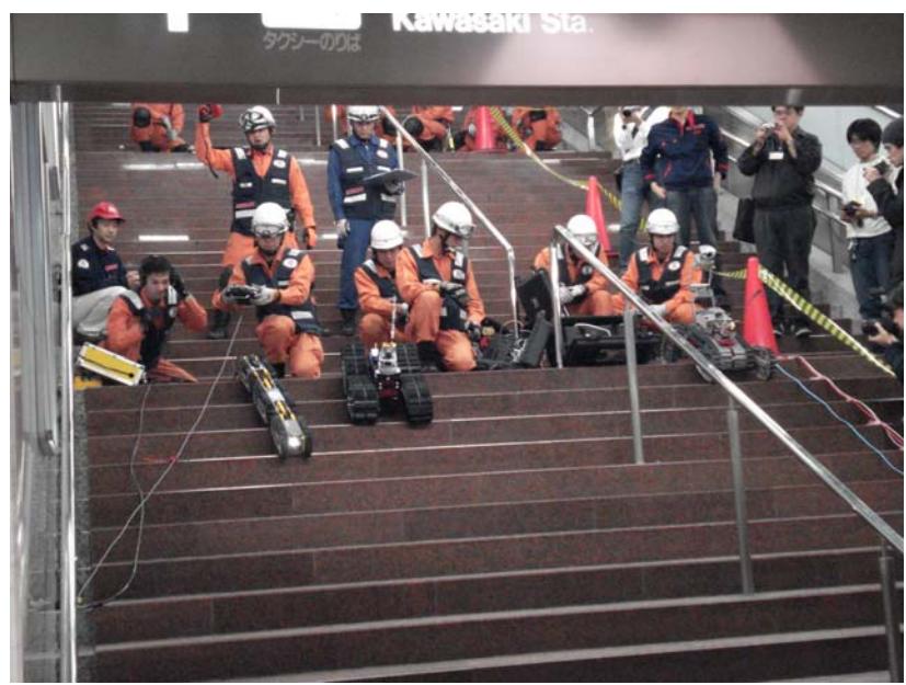 Fig. 16 KOHGA2(center robot) used by Japanese fire fighter in underground city