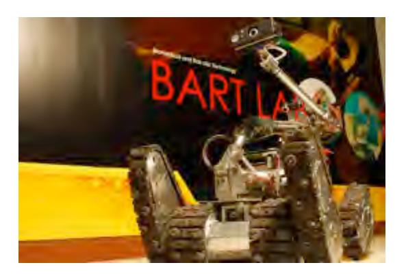 Fig. 1. The TeleOpIII, one of our two tele-operative robots in BART LAB Rescue team. The TeleOpIII employs tracked locomotion system with 4 independent flippers, and equips with an inverse-kinematically controlled manipulator to enhance more ability to search and retrieve better victim information, similar to other robots in [1,2].