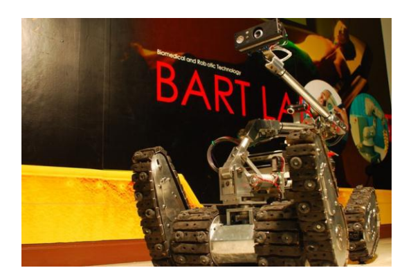 The TeleOpIII, one of our two tele-operative robots in BART LAB Rescue team. The TeleOpIII employs tracked locomotion system with 4 independent flippers, and equips with an inverse-kinematically controlled manipulator to enhance more ability to search and retrieve better victim information, similar to other robots in [1,2]