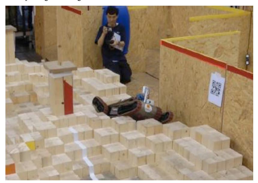 Fig. 4. WMR robot overcoming red zone step fields in the 2012 German Open Mobility Challenge.