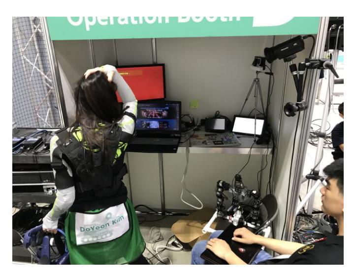 Fig. 3. Demonstrate of visual control set up: HTC vive headset visual system, multi-screen view; and robot manipulation set up: tele-suit control, mannequin control and support operator control