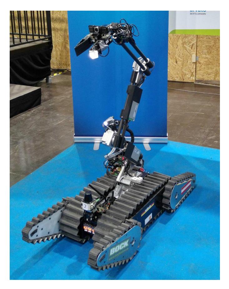 Fig. 1. Robot Schroedi equipped with a 7-DOF manipulator for inspecting points of interest up to a height of 1.5 m and grasping objects. This robot is capable of driving in rough terrains.