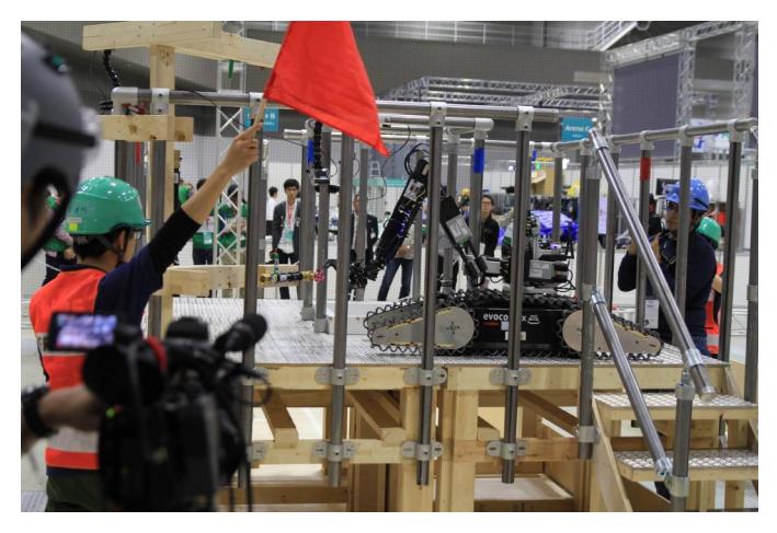 Fig. 3. Schroedi at the finals Tokyo. Image shows Schroedi scoring points by manipulating vents on a stair case. The robot had to climb the stairs up and manipulate levers and vents.