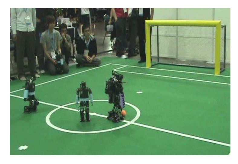 Fig 1. Our previous kid size humanoid robot in the competition field of RoboCup 2010.