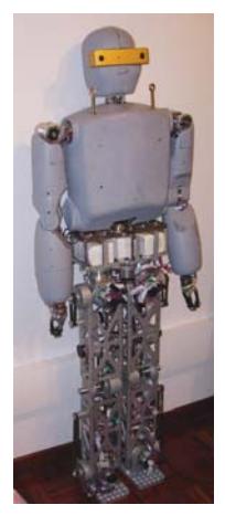 Two images of Arabot, the first standing (left) and the second performing autonomously chess playing against a human (right).