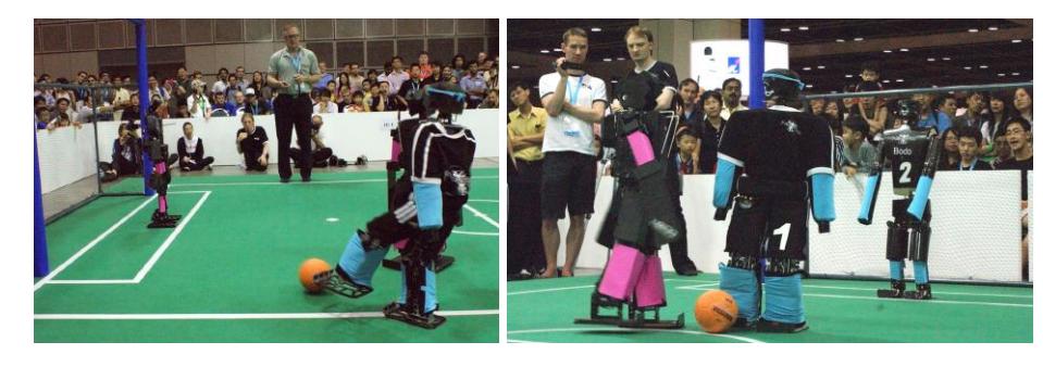 Fig. 1. RoboCup 2010 TeenSize finale: NimbRo vs. CIT Brains. Our team played with the robots Dynaped (field player) and Bodo (goalie).