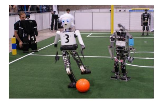 Left: NimbRo robots Dynaped, Copedo, and Bodo playing in the 3 vs. 3 demo game at RoboCup 2012. Right: Copedo performing the ThrowIn Challenge.