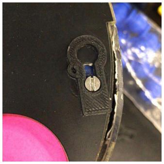 Fig. 10: (a) Cover lock (b) Rubber gimbal utilized as a spring