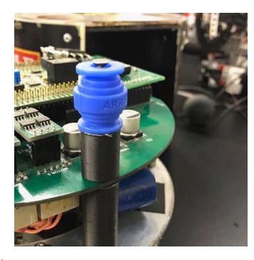 Fig. 10: (a) Cover lock (b) Rubber gimbal utilized as a spring