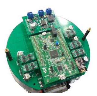 Fig. 4: Picture showing all boards: the kicker module at the top, the stamp module at the center, five motor modules at the sides and one communication module at the corner. Beneath all, the main board.