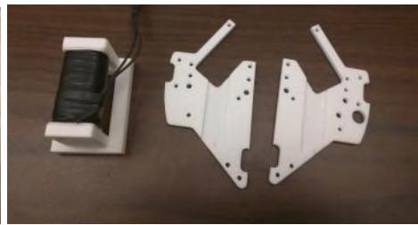 Fig. 2: Examples of 3D printed hardware we are experimenting with. (a) Dribbler Backstop (b) New Kicker Solenoid and Mid Plates