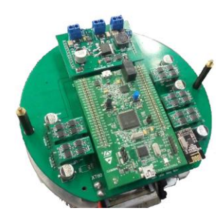 Picture showing all boards: the kicker module at the top, the stamp module at the center, five motor modules at the sides and one communication module at the corner. Beneath all, the main board.