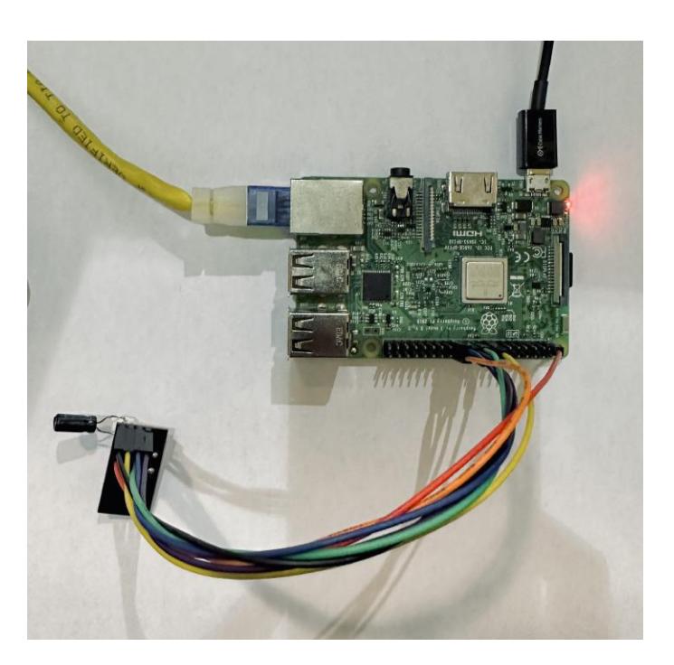 Prototype setup: Raspberry Pi 4 connected with jumper wires to an nRF24L01 transceiver, and connected to our software via Ethernet