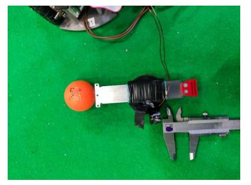 Solenoid without case and the ball placed against the solenoid.