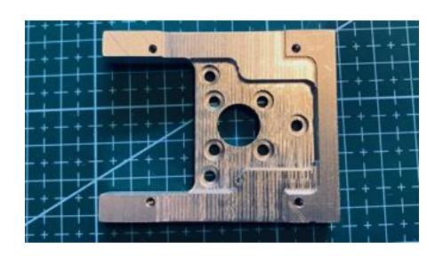 Fig. 4: Left: Motor mount Right: Completed drive with motor mount, wheel, and controller.