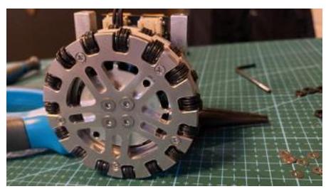 Fig. 4: Left: Motor mount Right: Completed drive with motor mount, wheel, and controller.
